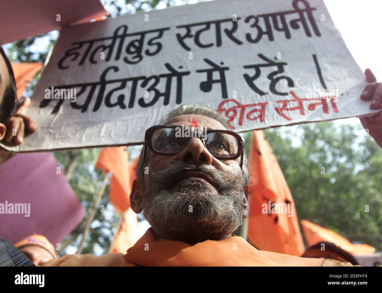 An activist from the hard-line Hindu party Shiv Sena holds a poster with the inscription An activist from the hard-line Hindu party Shiv Sena holds a poster with the inscription