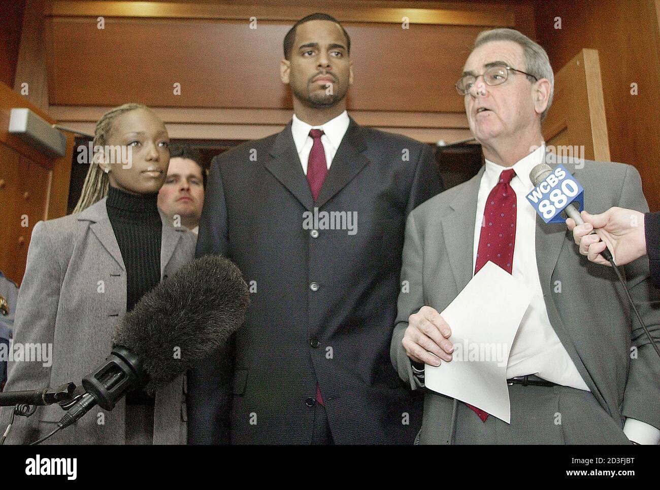 Former New Jersey Nets star basketball player Jayson Williams (C) and his  wife Tanya (L) listens as his lawyer Joseph Hayden makes a statement after  he made a first appearence in Hunterdon