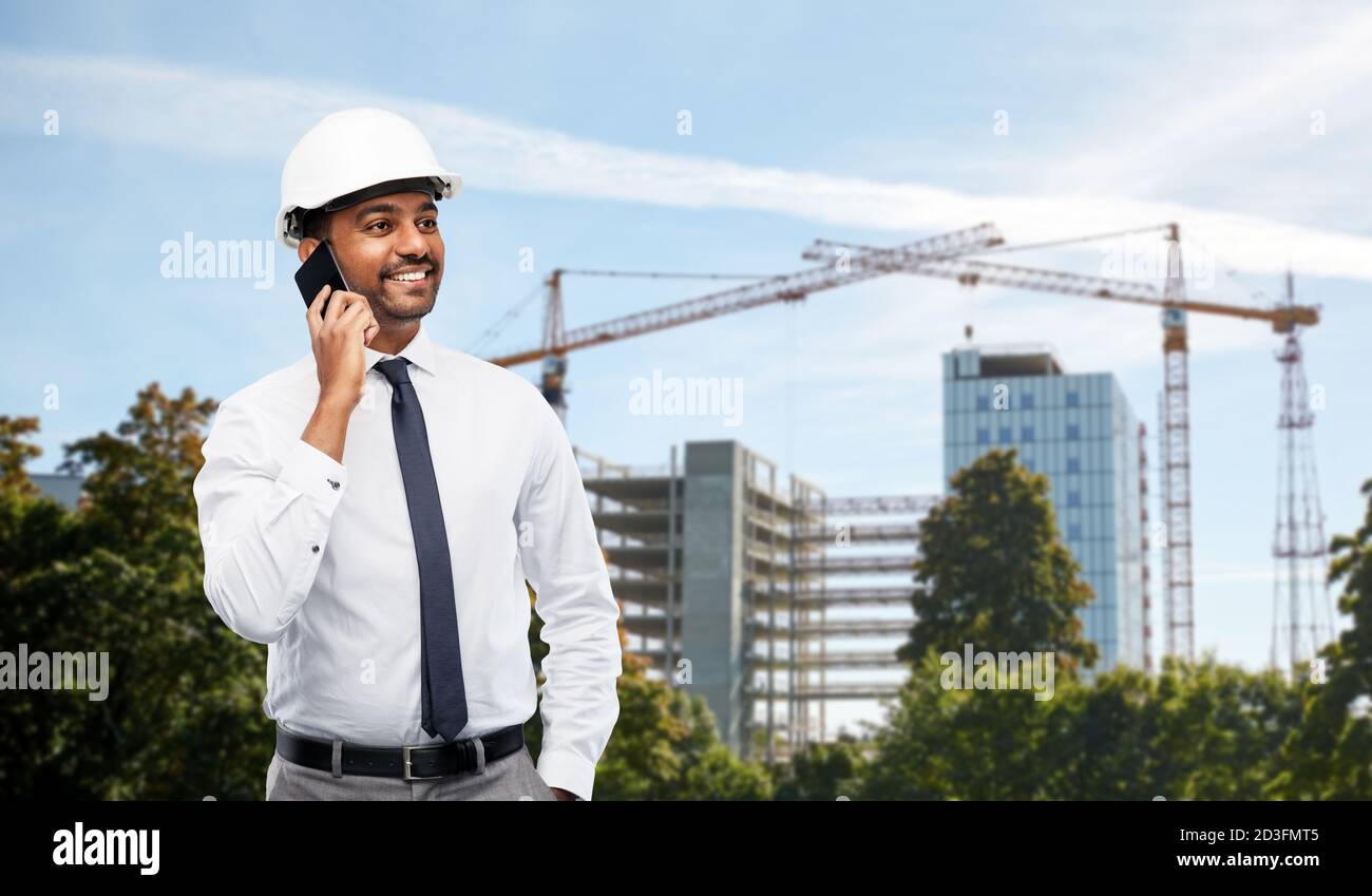 architect calls on smartphone at construction site Stock Photo
