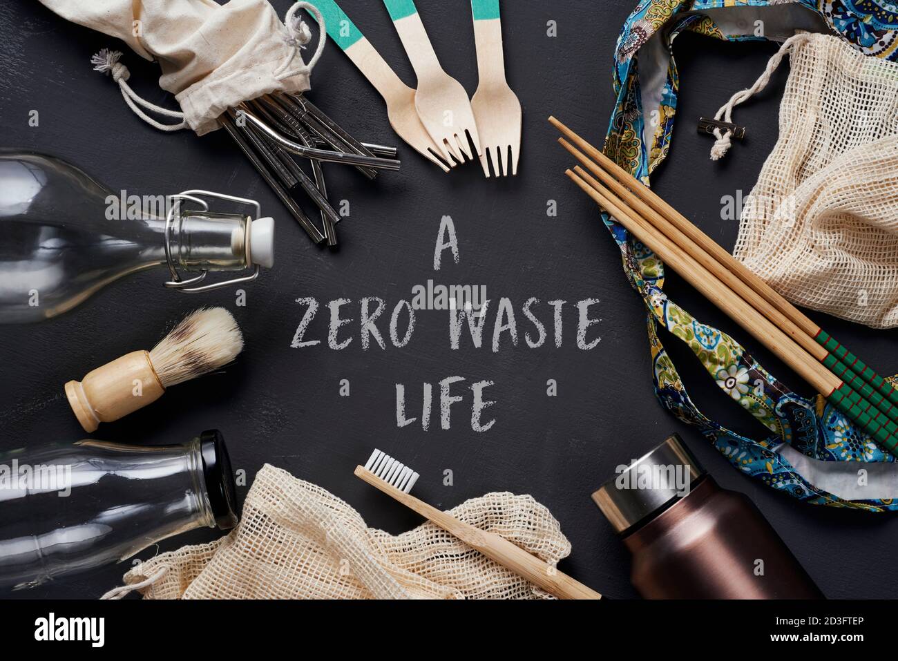 a pile of no-plastic sustainable household items, such as refillable metal and glass bottles, shopping mesh bags, or reusable wooden toiletries, cutle Stock Photo