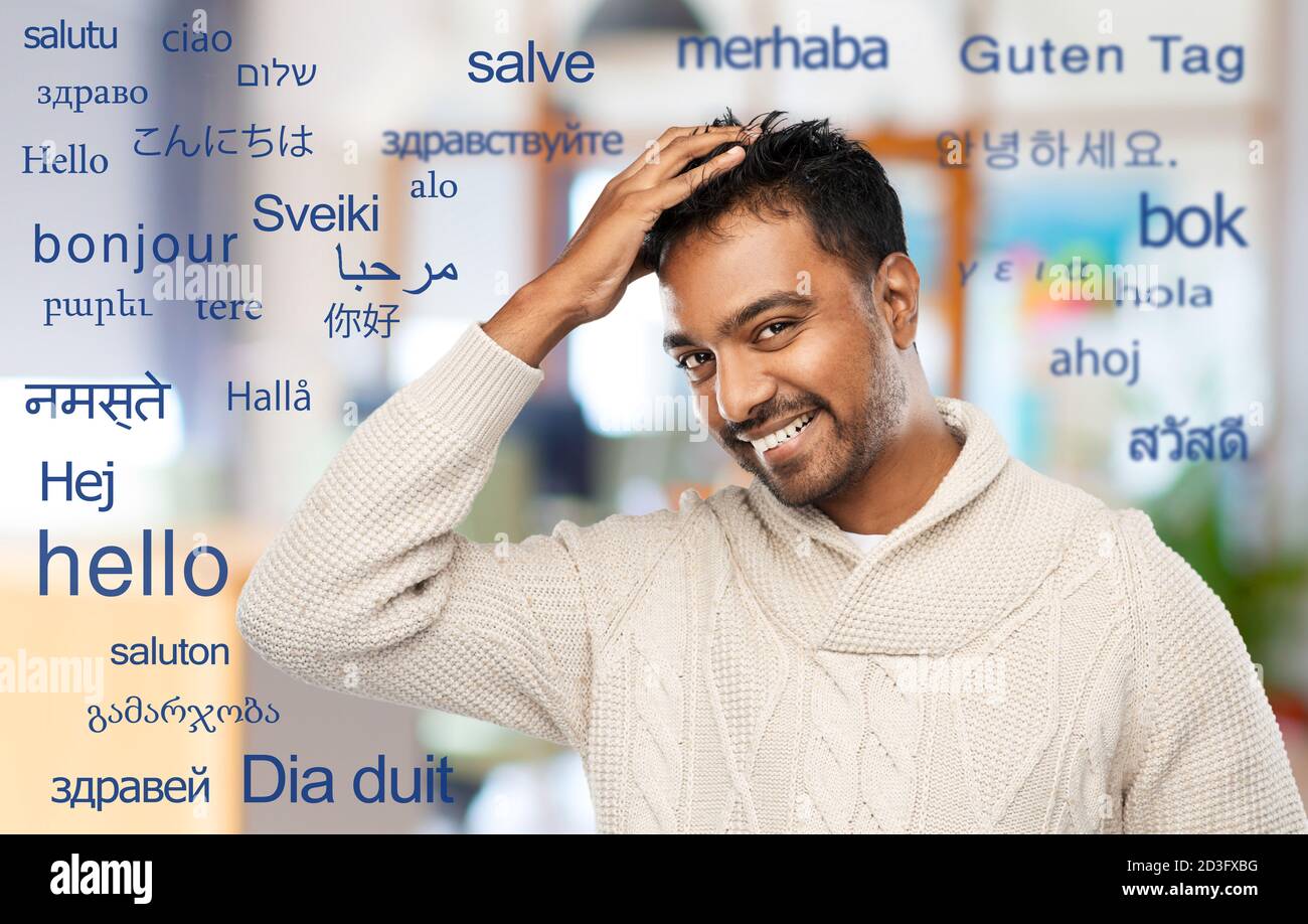 indian man in knitted sweater touching his hair Stock Photo
