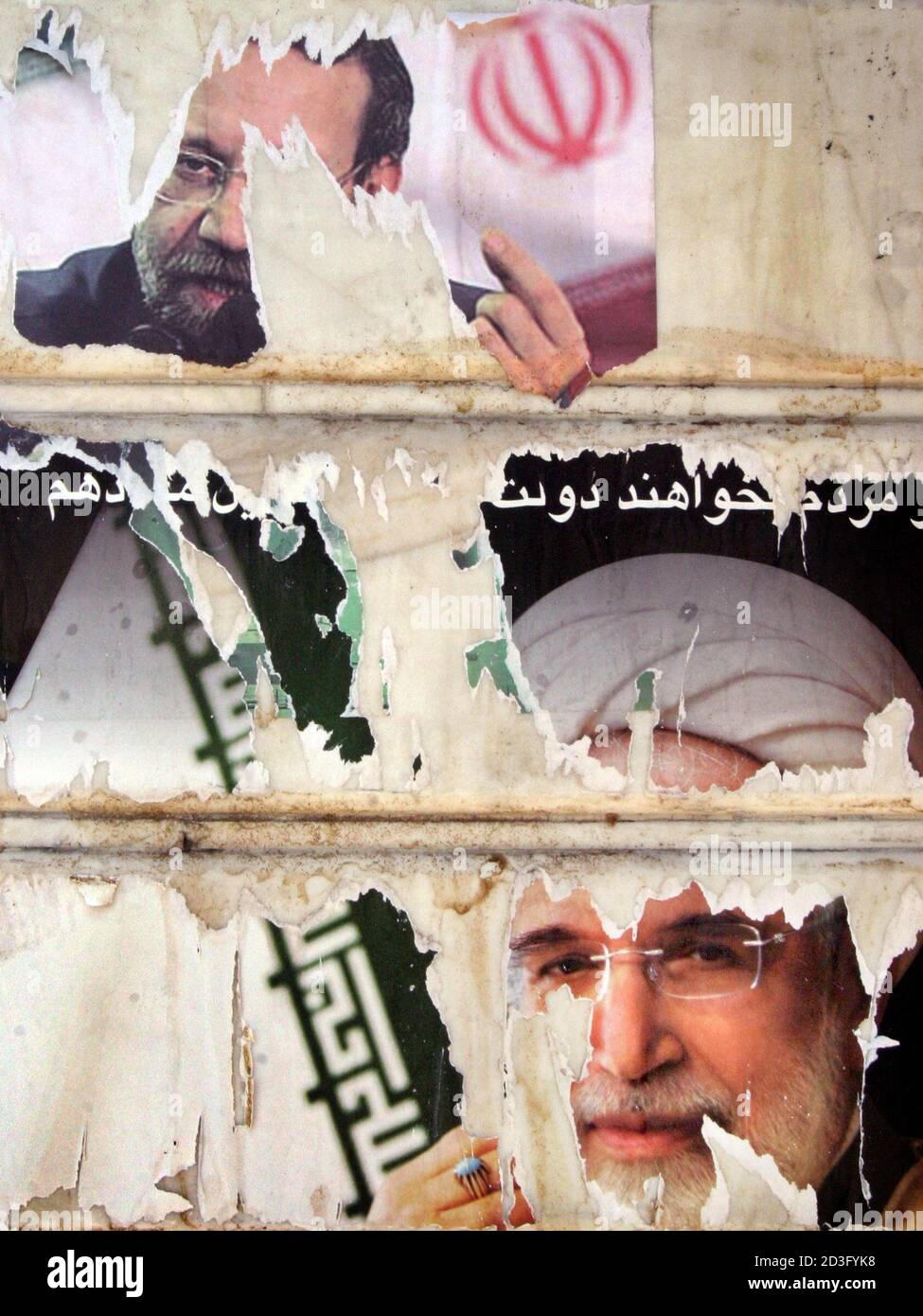Torn campaign posters line the walls of Damavand, 60 km (37 miles) east of Tehran, June 15 2005. The campaign began almost as a one-horse race, but after more than two weeks of campaigning that ended on Thursday, Akbar Hashemi Rafsanjani's lead has sharply eroded and his chances of securing the 50 percent vote needed for a first-round win seem slim. The race is the tightest in Iran's history with reformist Mostafa Moin and conservative Mohammad Baqer Qalibaf, who both ran vigorous campaigns, in second and third place according to opinion polls, although polls have been unreliable in the past.  Stock Photo
