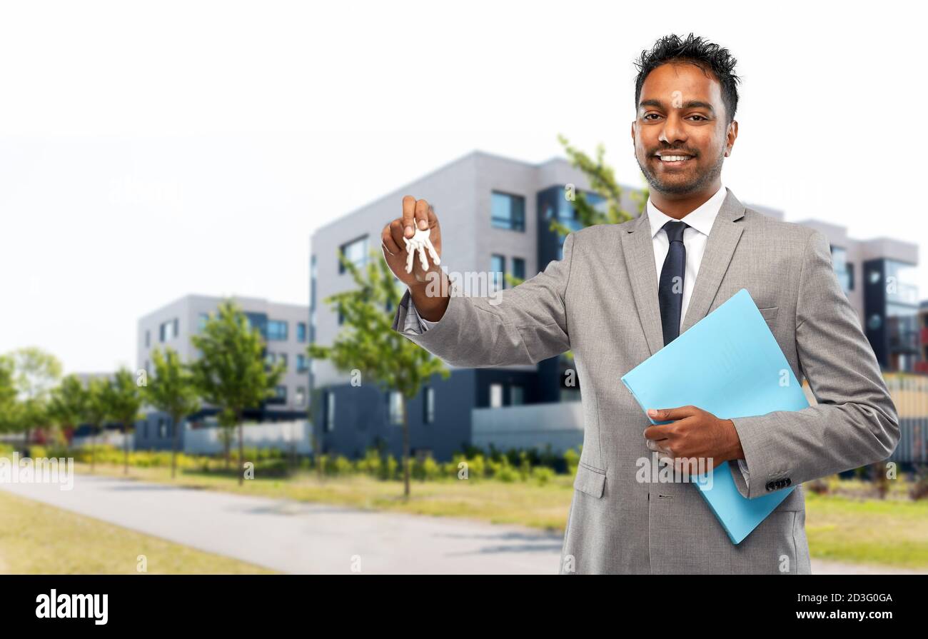 indian man realtor with key and folder in city Stock Photo Alamy