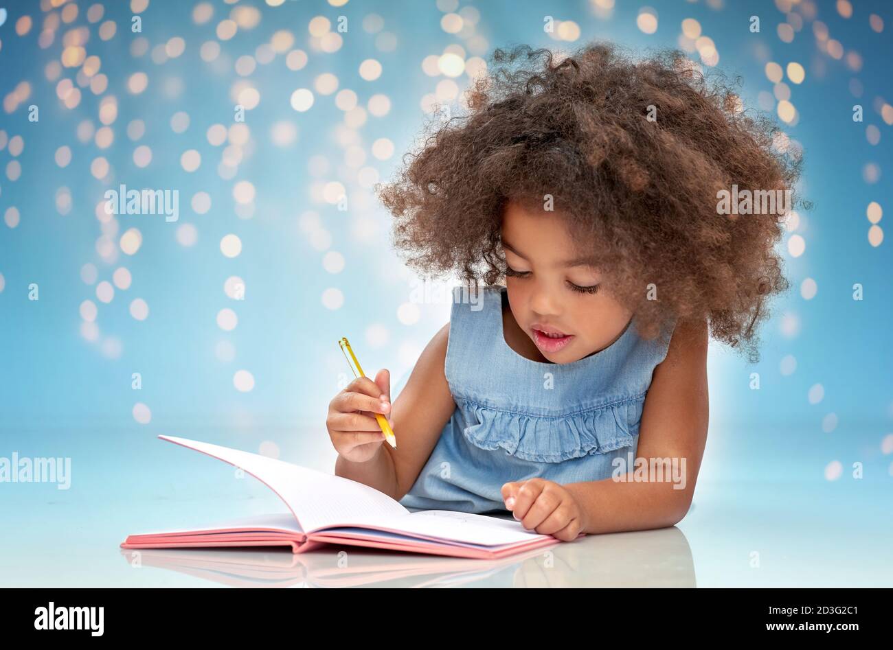 happy little african american girl with sketchbook Stock Photo - Alamy