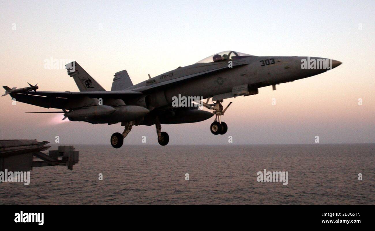 An F/A-18C Hornet warplane is launched off the USS Abraham Lincoln (CVN 72) in the North Arabian Sea on October 14, 2002. Ships from the Lincoln Battle Group are in the region to support Operation Enduring Freedom. Stock Photo