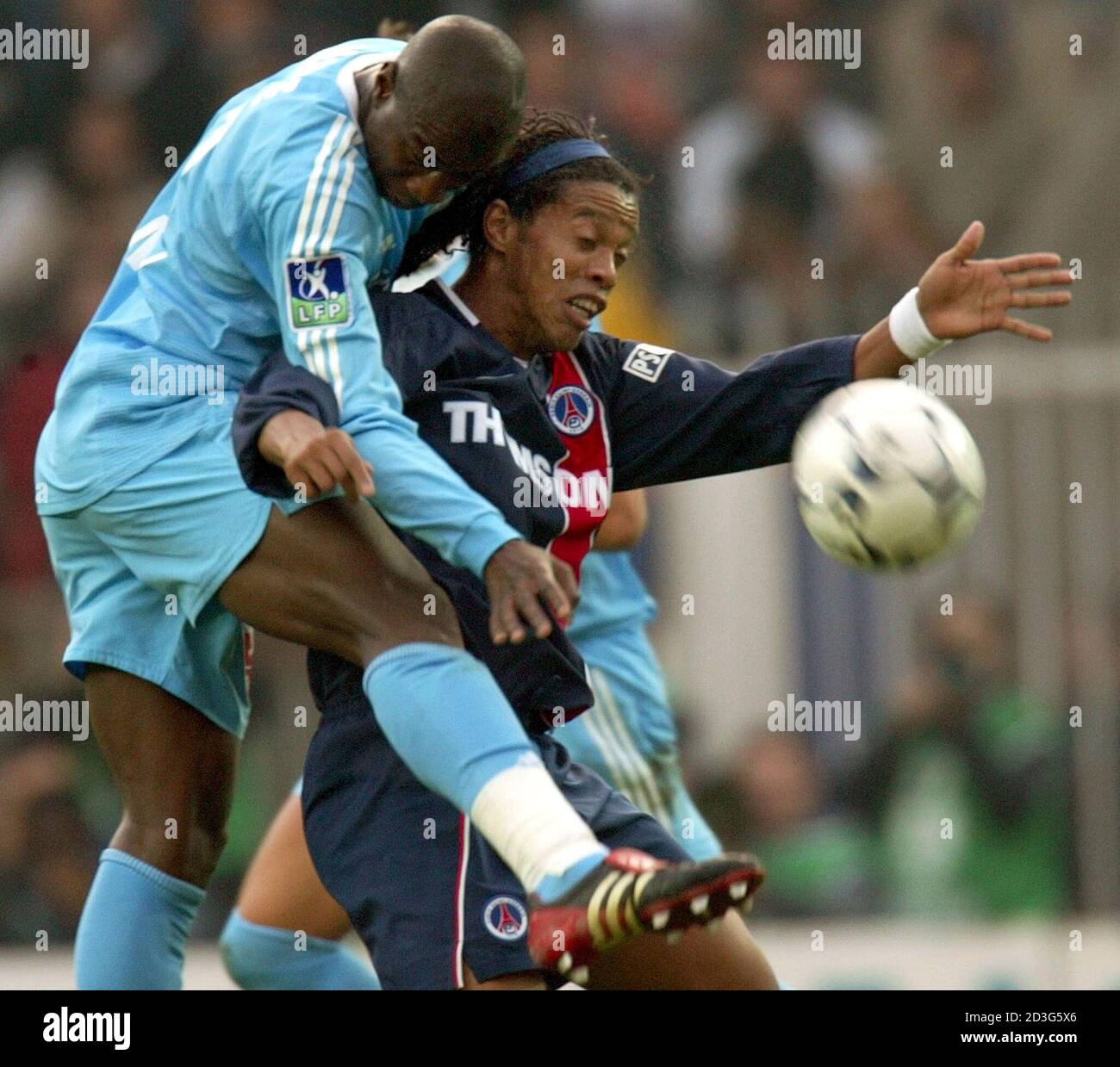 Brazilian striker Ronaldinho of Paris Saint Germain (R) and Cameroon  defender Salomon Olembe of Marseille try to control the ball in their  French first division soccer match at Paris'parc des Princes stadium