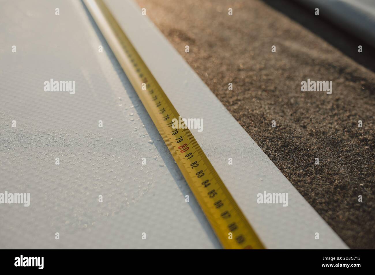Tape measure unfolded on amembrane roof Stock Photo Alamy