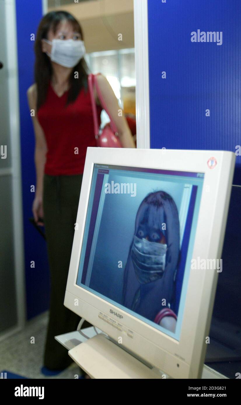An Airline Passenger Walks Past A Thermal Imaging Scanner Used To Detect Potential Sars Carriers At Kuala Lumpur International Airport May 20 2003 Malaysia On Monday Called On Rich Nations Like United