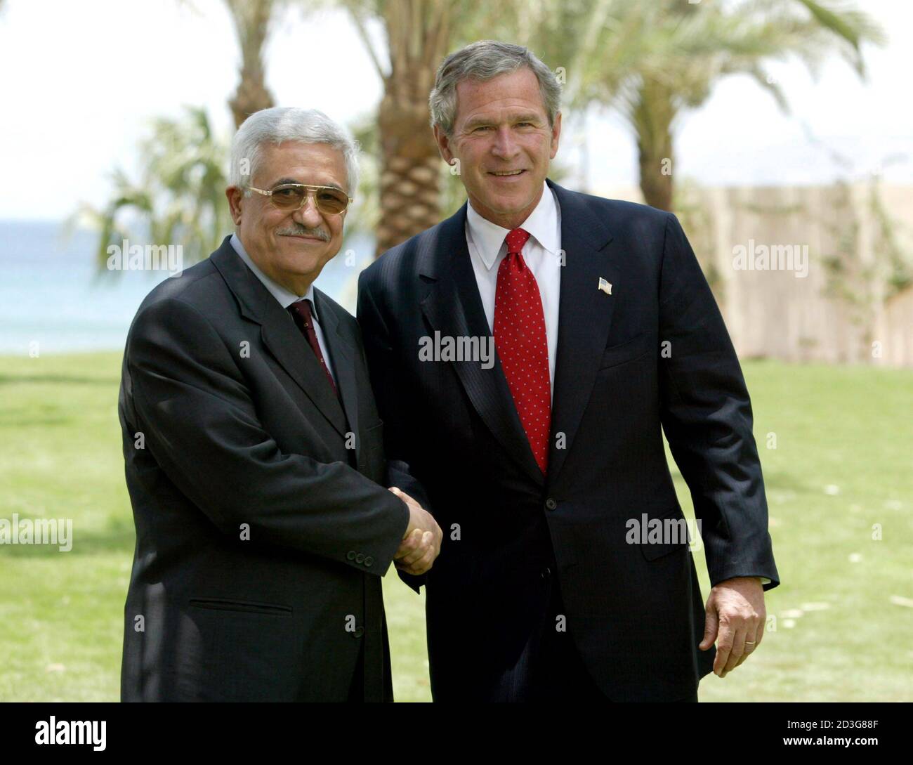 U.S. President George W. Bush (R) meets with the Prime Minister of Palestine Mahmoud Abbas at the Summer Palace in the southern Jordanian port town of Aqaba June 4, 2003. [One of the most important aspects of Bush's week-long trip to Europe and the Middle East will be a trilateral meeting between Abbas and Israeli Prime Minister Ariel Sharon on Wednesday, intended to win their commitment to implementing a 'road map' to Middle East peace.] Stock Photo