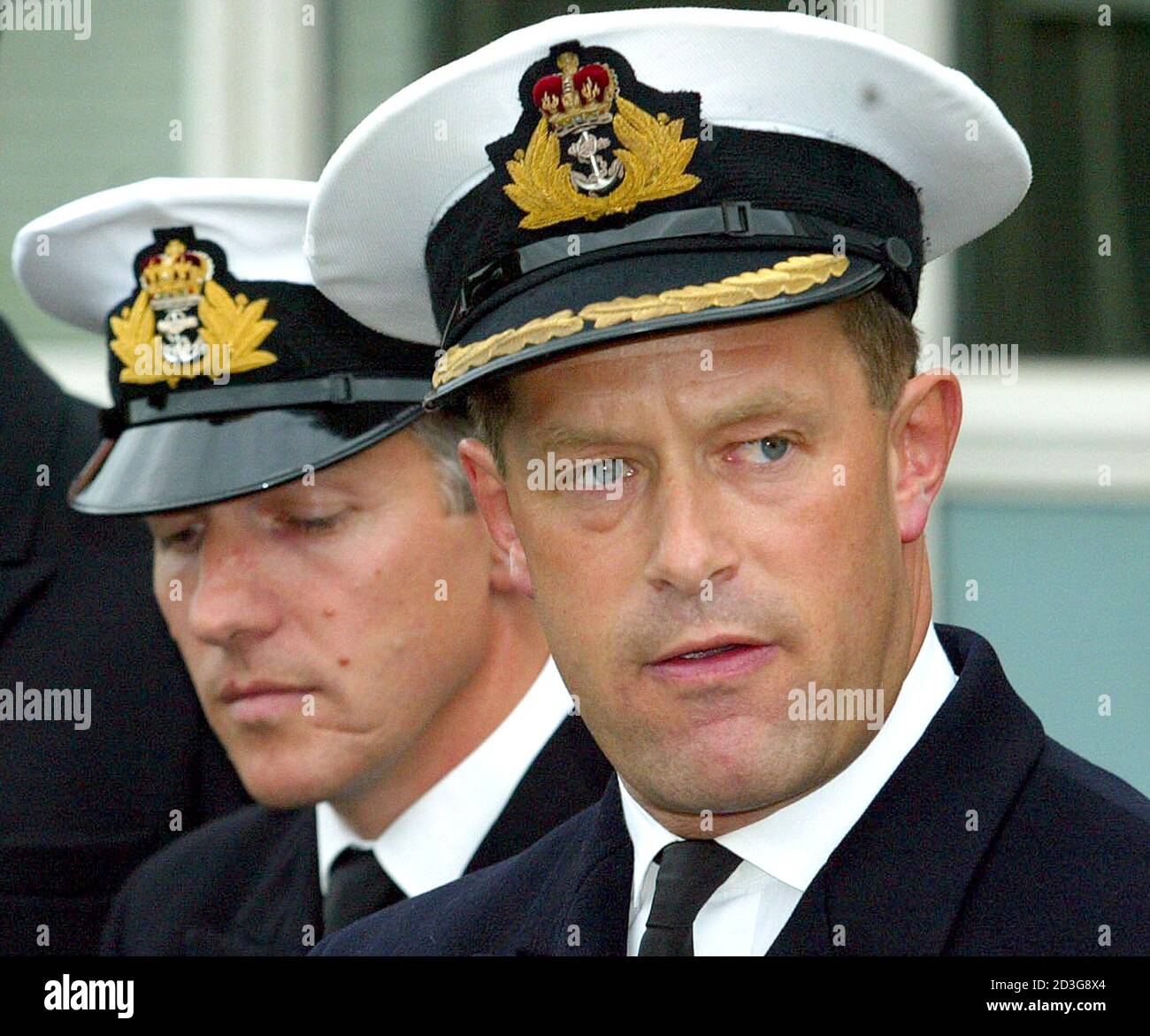 Lieutenant Commander John Lea and Commander Richard Farrington (R) address the media after a court martial hearing at Portsmouth Naval Base, September 11, 2003. Commander Farrington was reprimanded for neglecting his duties and Lea was was dismissed from his duties on Thursday after their vessel HMS Nottingham ran aground near Lord Howe Island, 200 miles off the coast of Australia in July 2002, tearing a 100 ft hole down the side of the Type 42 destroyer and incurring a 42 million pounds ($66, 851, 400) repair bill. REUTERS/Lee Besford  MD/JV Stock Photo