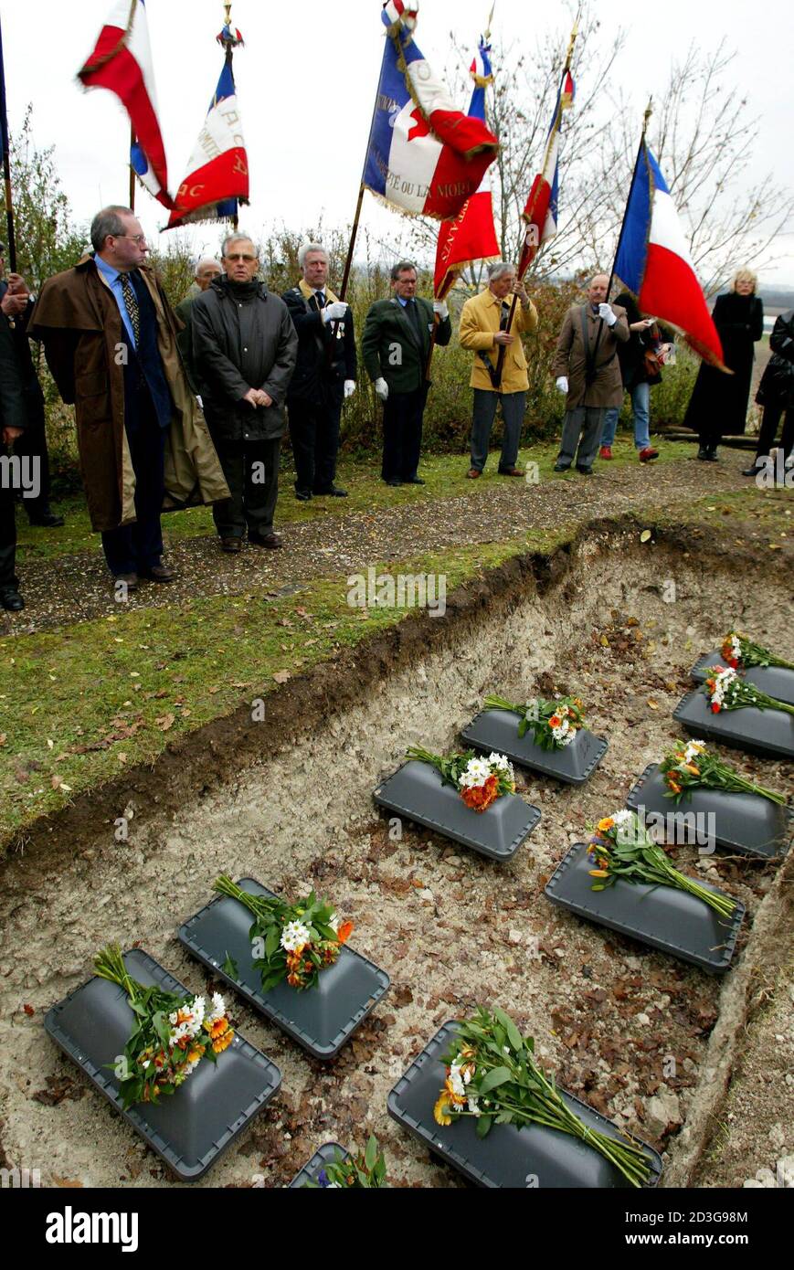 French veterans assist in a ceremony to bury the remains of 17 German soldiers shot at the end of WWII in a field in Saint Julien de Cremps, south western France November 16, 2003. The remains of the soldiers, executed by French resistance militiamen, were unearthed and are to be given proper burials during a ceremony at the German military cemetary in Berneuil. REUTERS/Regis Duvignau  RD Stock Photo