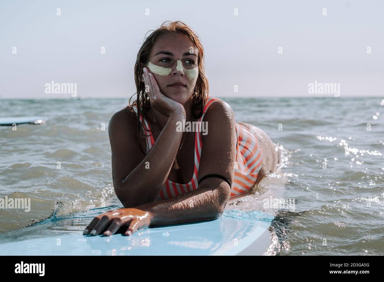 Female lying on her surfboard Stock Photo Alamy