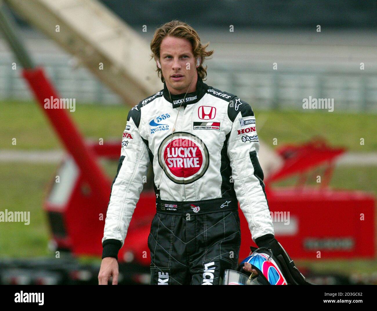 BAR Honda driver Jenson Button of Great Britain walks away from the track  after having to abandon his smoking car during the 2004 Brazil Grand Prix  in Sao Paulo, October 24, 2004.