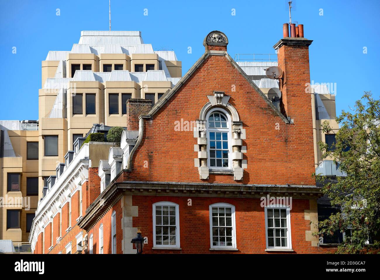 London, England, UK. Contrasting architectural styles: old and new buildings on Bow Street / Long Acre. (90 Long Acre behind) Stock Photo