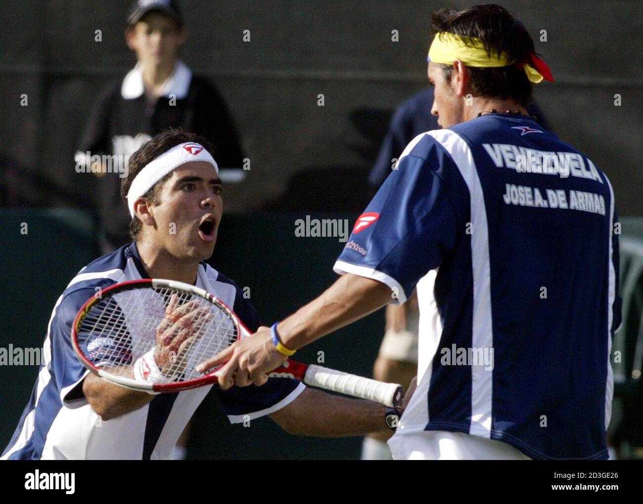 Venezuelan Jhony Romero (L) and Jose Dearmas celebrate after winning a point against Luis Horna and Ivan Miranda of Peru during their Davis Cup doubles match in Caracas, March 5, 2005 REUTERS/Howard Yanes  HY Stock Photo