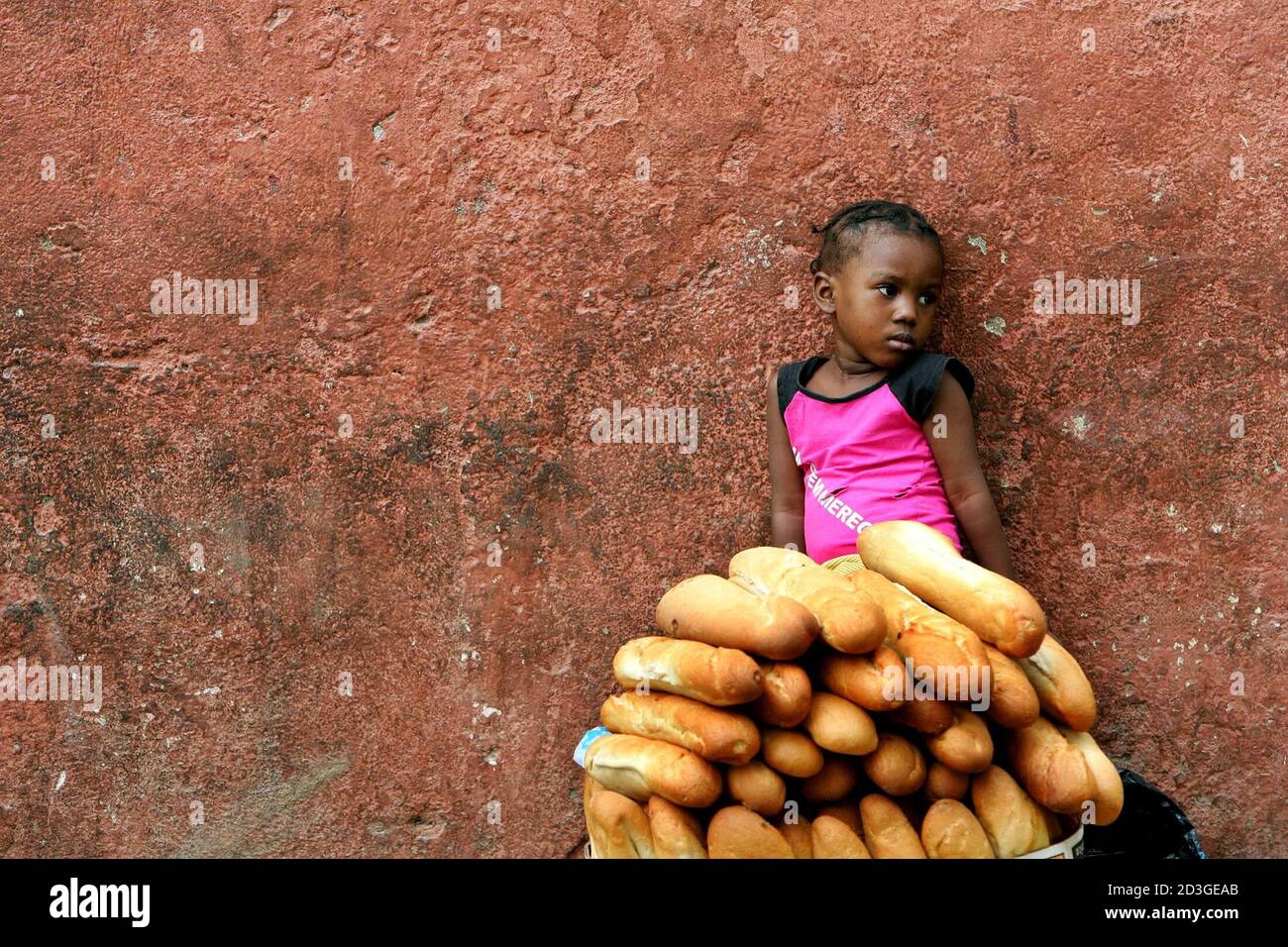 An Angolan child sells bread on the street in the country's capital Luanda, April 17, 2005. [Angolan priests urged their congregations Sunday to abandon their fear of hospitals so that loved ones could receive treatment for the Marburg virus that has killed more than 200 people. Early in the outbreak, aid agency Medecins Sans Frontieres,one of the only groups operating in the northern Uige Province, said poor infection control at the hospital there was to blame for some of the cases.] Stock Photo
