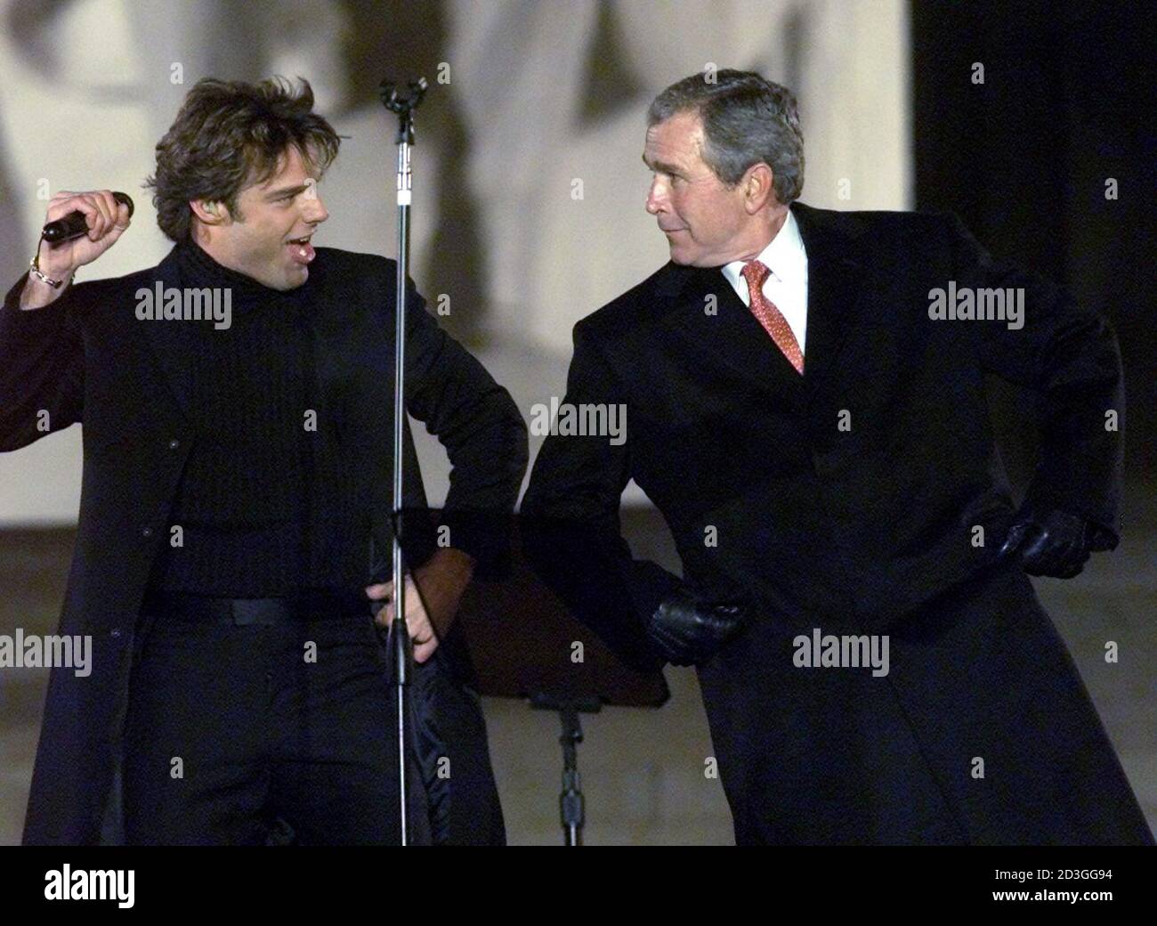 President-elect George W. Bush (R) dances with singer Ricky Martin at the opening ceremony of the inauguration at the Lincoln Memorial in Washington January 18, 2001. Bush will be sworn in as the 43rd president on January 20. Stock Photo