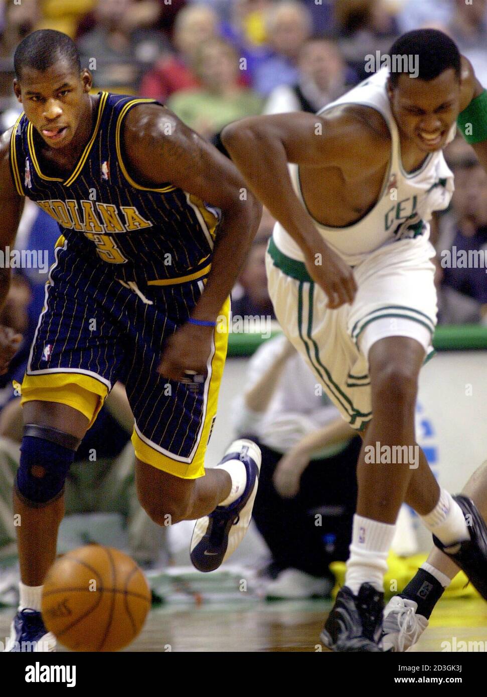 The Indiana Pacers Al Harrington (L) and the Boston Celtics Paul Pierce (L)  chase down a loose ball in first half NBA action in Boston, Massachusetts  November 14, 2001. REUTERS/Brian Snyder BS