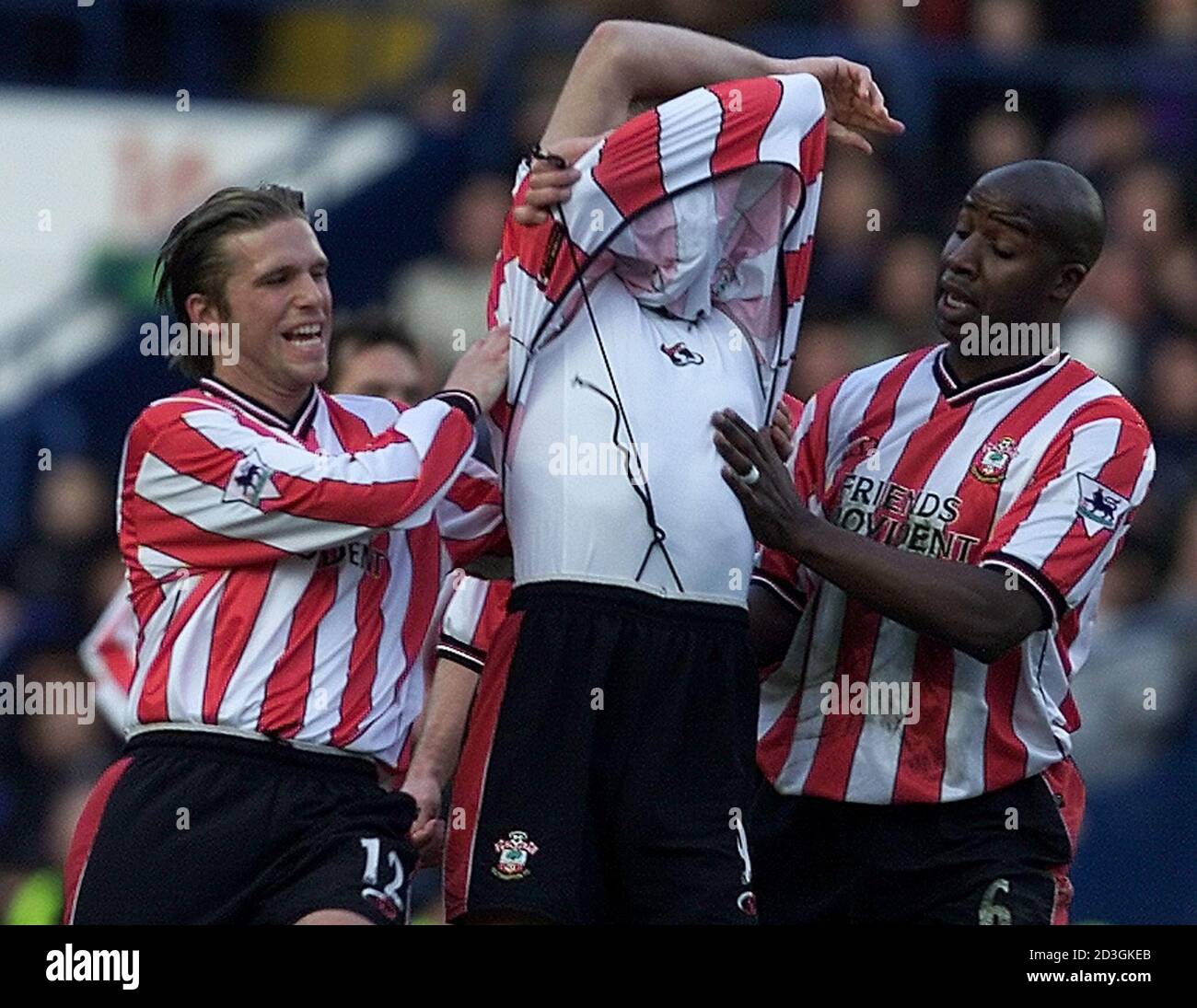 Southampton's James Beattie (C) tears his shirt off as he celebrates his goal with team mates Anders Svensson (L) and Paul Williams during their english premier league match against Chelsea at Stamford Bridge January 1, 2002. NO INTERNET/ONLINE USAGE WITHOUT FAPL LICENCE. FOR DETAILS SEE FAPLWEB.COM. REUTERS/Ian Waldie  IW/PS Stock Photo