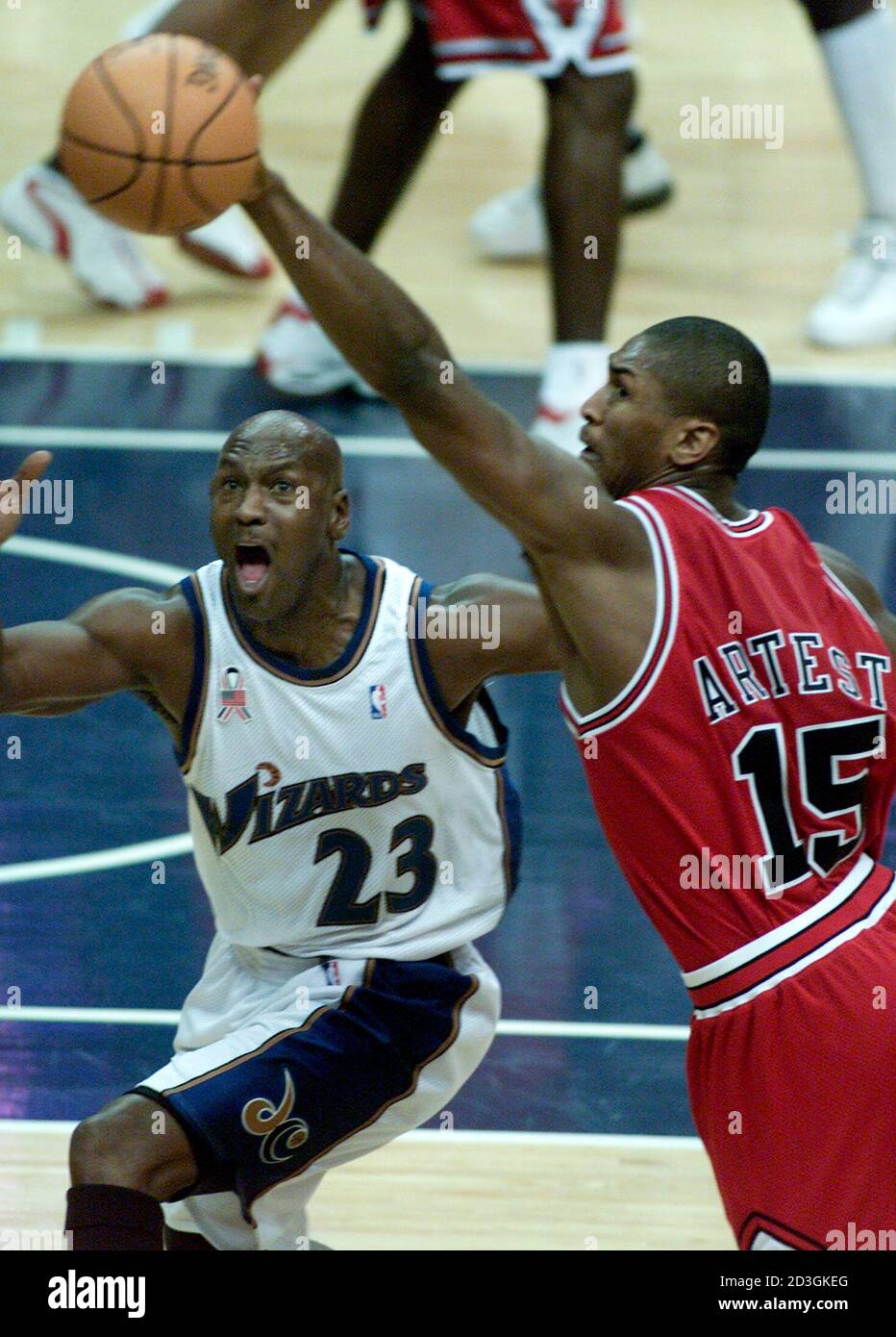 Chicago Bulls' Ron Artest (R) reaches to slap a pass away that was intended  for Washington Wizards' Michael Jordan (L) in the first quarter of their  game at the MCI Center in