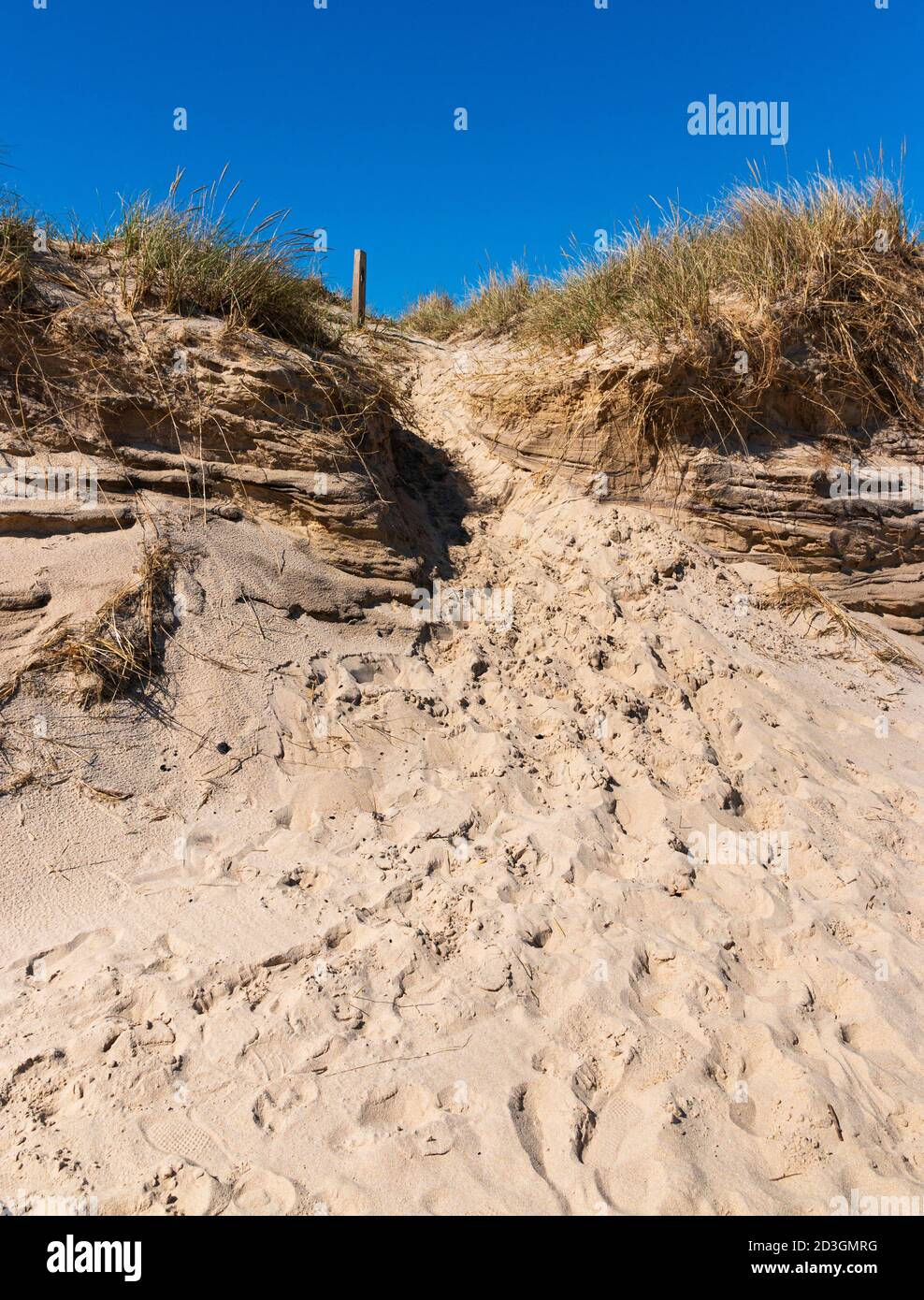A sand dune on Montauk Beach not far from Montauk Point with footprints
