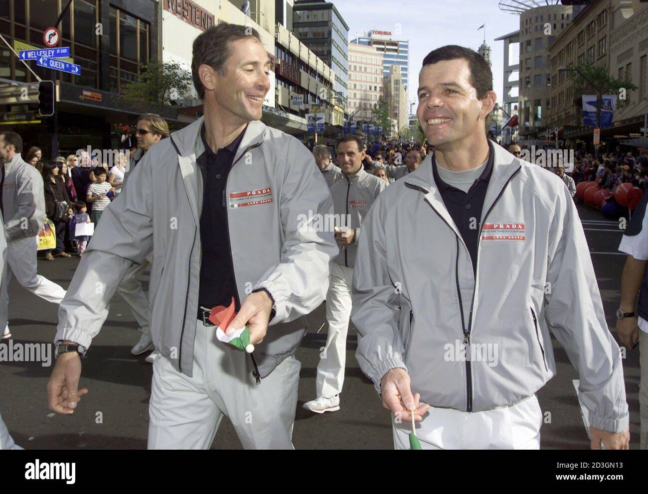 Italy's Prada Challenge skipper Francesco de Angelis (L) and tactician  Torben Grael laugh as they walk down Auckland's Queen St. during the  opening parade for the Louis Vuitton Cup and America's Cup