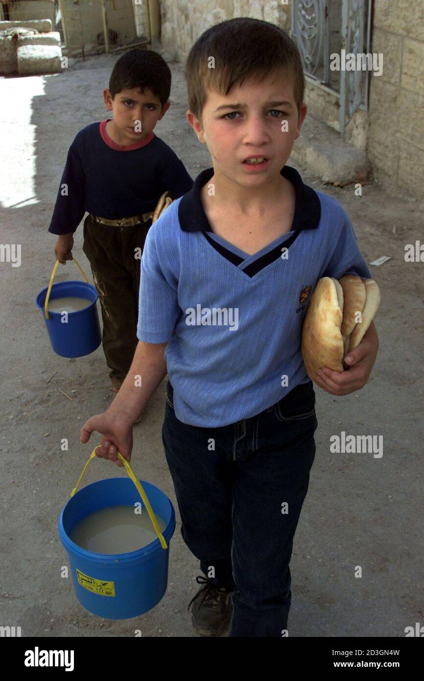 Two Palestinian Boys Carry Free Food They Received From The Islamic Aid Agency For The Palestinians In The Old City Of Hebron In The West Bank On October 23 02 U S Envoy Two Palestinian Boys Carry Free Food They Received From The Islamic Aid Agency For The Palestinians In The Old City Of Hebron In The West Bank On October 23 02 U S Envoy