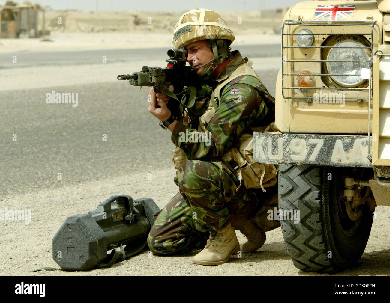A soldier of the British 7th Armoured Brigade sits with a rocket launcher as he keeps watch on road leading to the southern Iraqi town of Basra March 22, 2003. The United States and Britain unleashed their first daylight air strikes on Baghdad on Saturday after pounding it with a fearsome night blitz. After the bombing rose to a new intensity in the Iraqi capital, U.S. forces said they had captured a vital crossing point over the Euphrates river, and were battling towards Iraq's second city of Basra in the south. REUTERS/Jerry Lampen  JFL/ Stock Photo