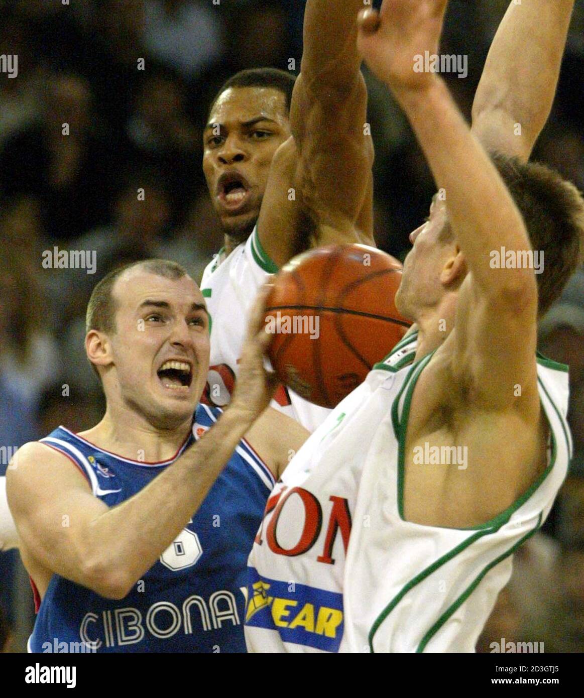 TEAMMATES VLADEMIR BOISA AND ALOYSIUS ANAGONYE OF UNION OLIMPIJA CHALLENGES SLAVEN RIMAC OF CIBONA AT THEIR EUROLEAGUE BASKETBALL MATCH IN LJUBLJANA. Teammates Vlademir Boisa (R) and Aloysius Anagonye (top)of Union Olimpija (Ljubljana,Slovenia) challenges Slaven Rimac (6) of Cibona,(Zagreb, Croatia) during their Euroleague match in Ljubljana, February 19, 2004. Stock Photo