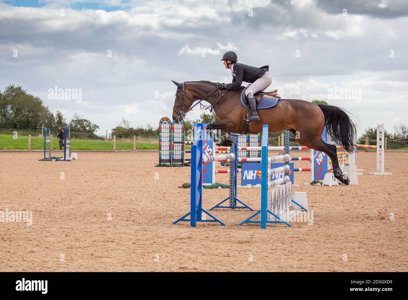 Horse riders competing in a showjumping competition Stock Photo - Alamy