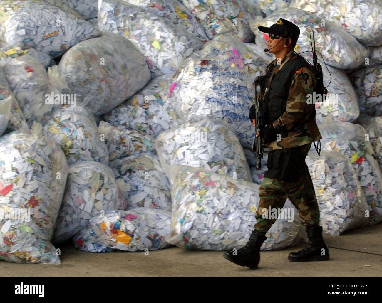 A Royal Thai air force commando guards bags containing some tens of  millions of paper birds representing peace inside a hanger in the southern  Thailand province of Hat Yai, nearly 933 km (
