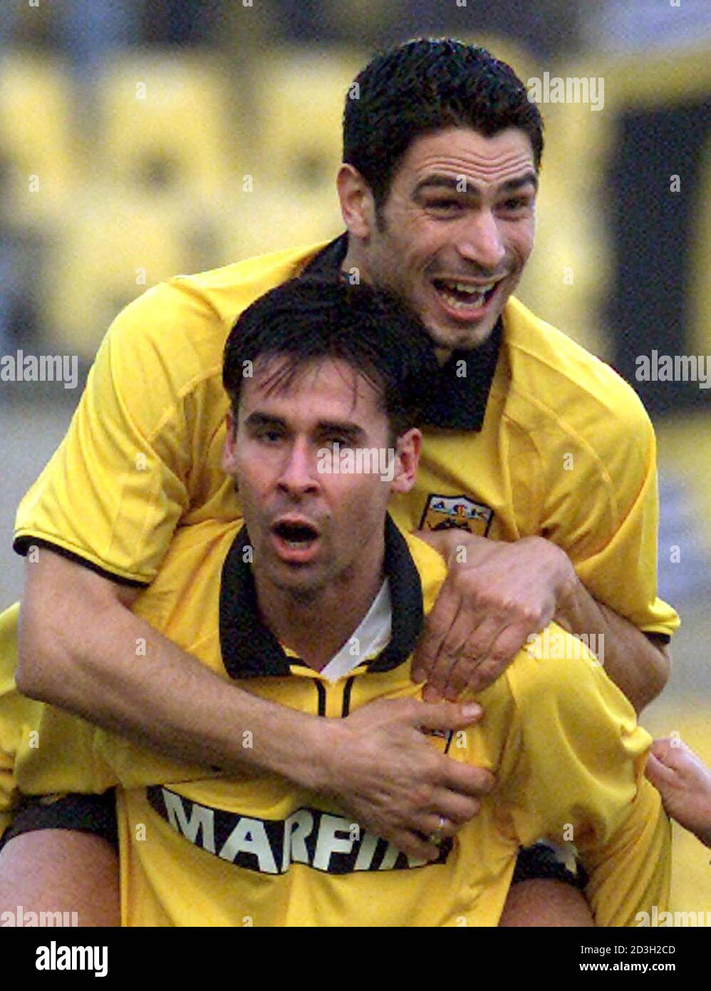AEK Athen's Vassilios Tsartas (front) and Andreas Zikos celebrate after  scoring a second goal against Bayer Leverkusen during a second leg third  round UEFA Cup soccer match in Athens' Nikos Goumas stadium