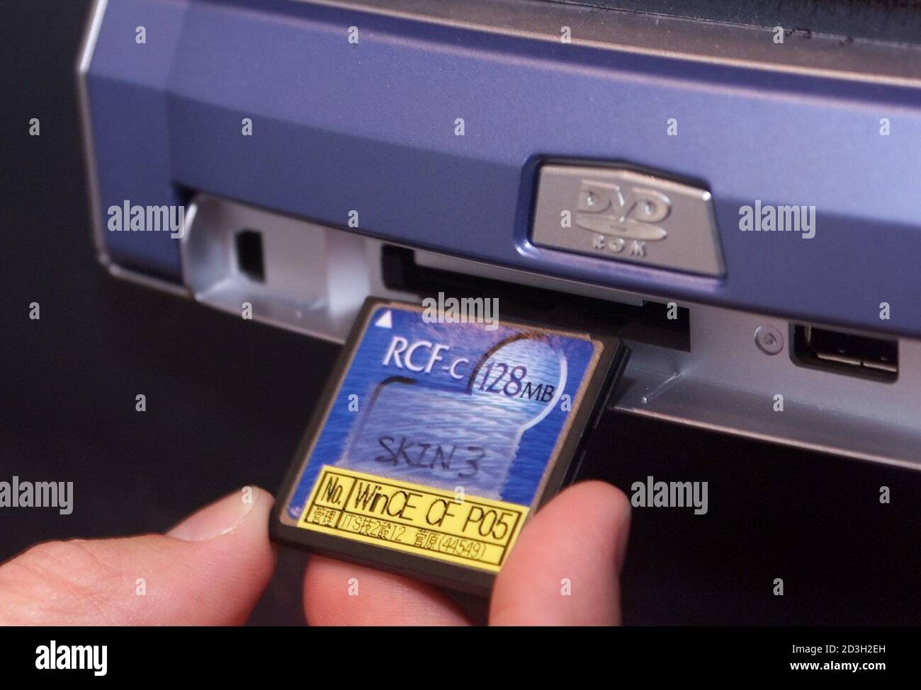 Jeff Murdock of Denso, inserts a flash memory card into a in-dash Windows  CE Navigation system during the Consumer Electronics Show January 7, 2001  in Las Vegas. The product, which should be