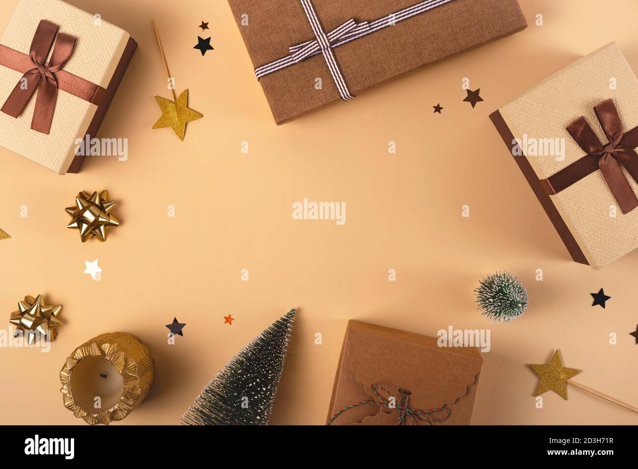 Three Christmas gift boxes on a neutral background among decorations Stock Photo