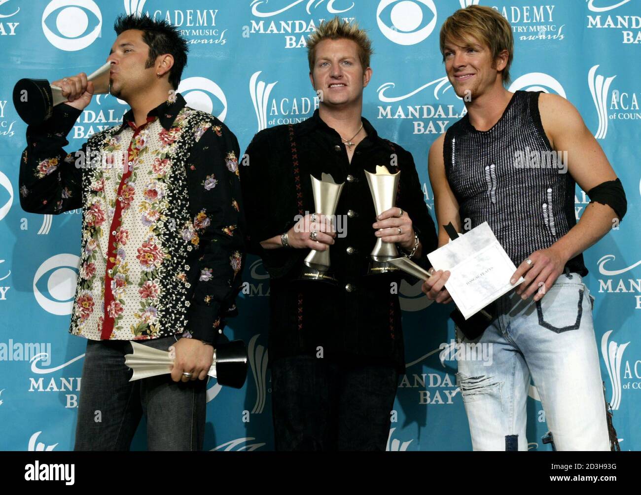 Members of the band Rascal Flatts pose with awards during the 38th Annual Academy of Country Music Awards show at the Mandalay Bay Resort  & Casino in Las Vegas, Nevada May 21, 2003. From L-R, Jay DeMarcus, Gary LeVox and Joe Don Rooney. The group won awards for Top Vocal Group and for Song of the Year -'I'm Movin'On. Stock Photo