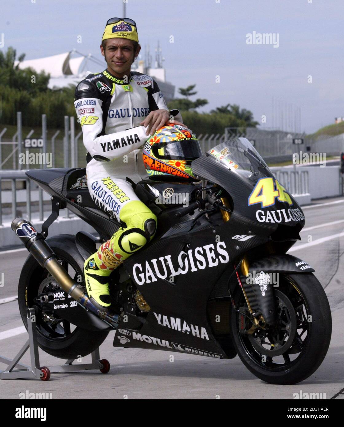 Motogp World Champion Valentino Rossi Of Italy Poses With His New Yamaha Yzr M1 Before Testing At Sepang International Circuit Near Kuala Lumpur January 24 04 Rossi And His Three Yamaha Teammates Will