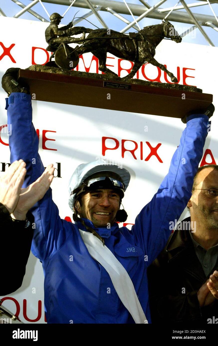 FRENCH JOCKEY JEAN-MICHEL BAZIRE DRIVING KESACO PHADO HOLDS HIS TROPHY  AFTER WINNING THE PRIX D'AMERIQUE RACE. French jockey Jean-Michel Bazire  driving Kesaco Phedo, holds his trophy after winning the Prix d'Amerique  harness