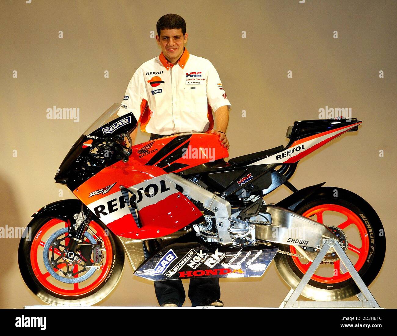 Brazilian rider Alex Barros poses for photographers with the new Honda  RC211V motorcycle during the presentation of the new Repsol Honda team in  Barcelona Spain, March 25, 2004. Barros and his team