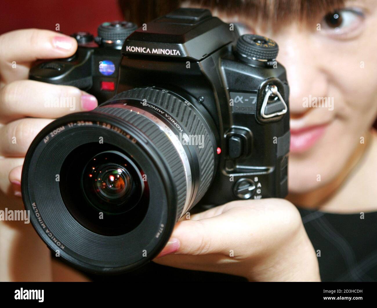 Japanese precision equipment maker Konica Minolta Holdings Inc. unveils its new digital single-lens reflex (SLR) camera 'Alpha-7 Digital' in Tokyo September 15, 2004. The camera with interchangable lenses is the world's first product equipped with technology which stabilizes image by shifting the CCD sensor inside the body to compensate for camera movements, the company said. Stock Photo
