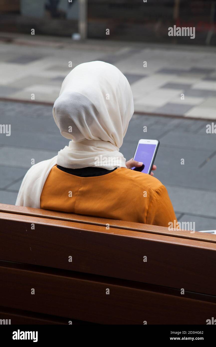YOUNG WOMEN with hijab look in her cellphone outdoor Stock Photo - Alamy