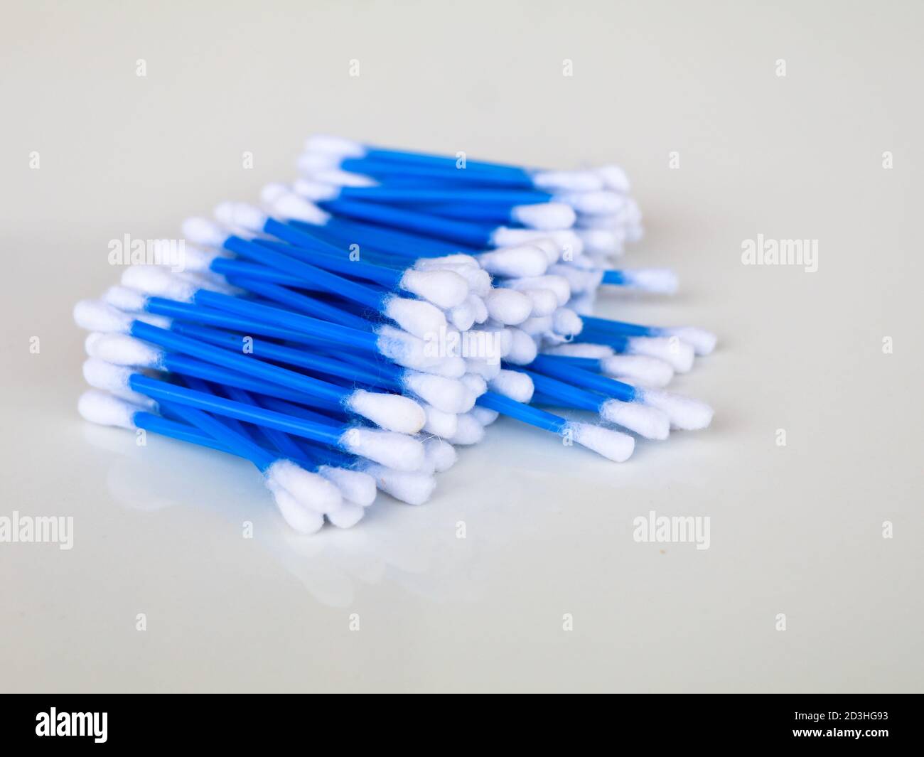Blue color ear cleaning buds in packets, against white background