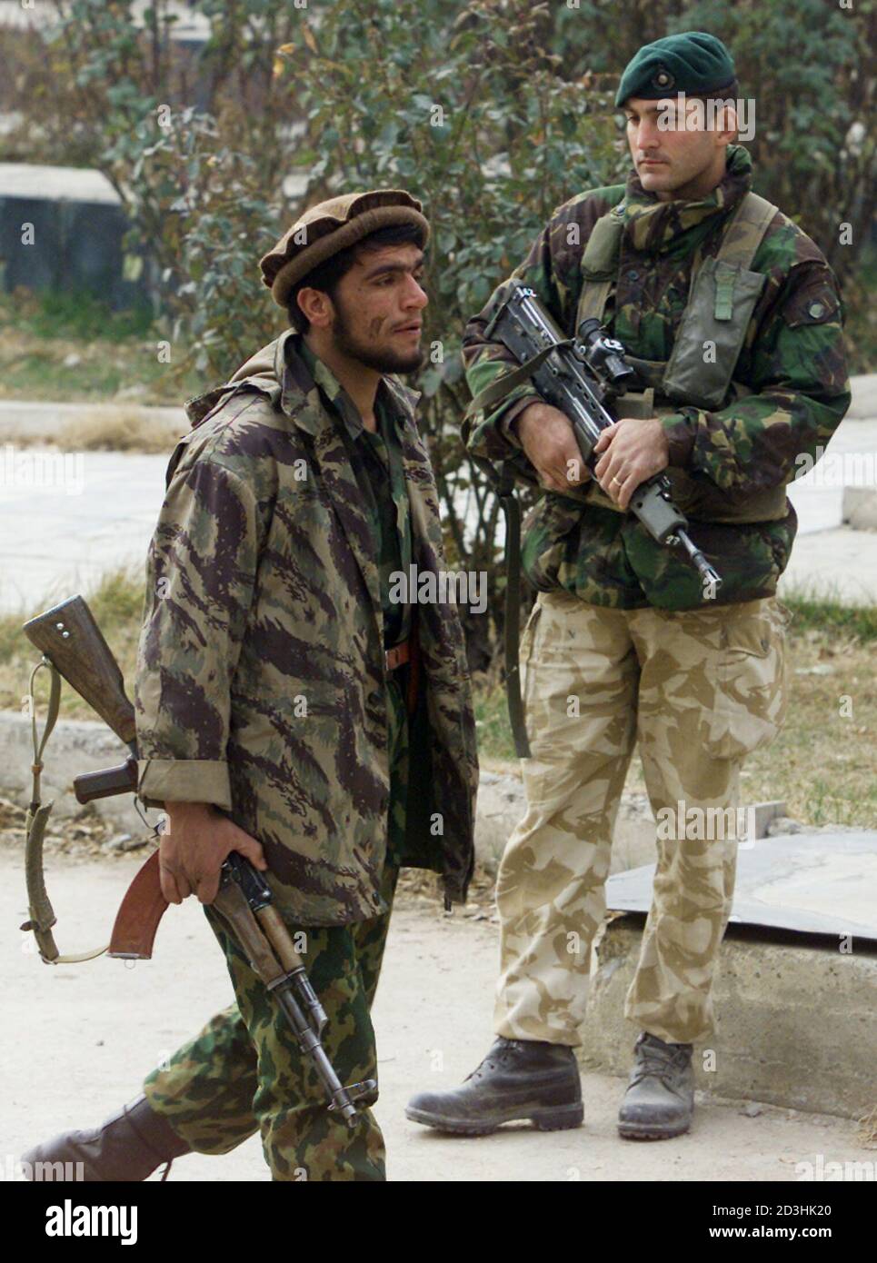 An Afghan Soldier Passes A British Royal Marine Who Stands Guard Outside The Interior Ministry Building In Kabul December 22 2001 Afghan Aristocrat Hamid Karzai Formally Took Up The Reins Of Power