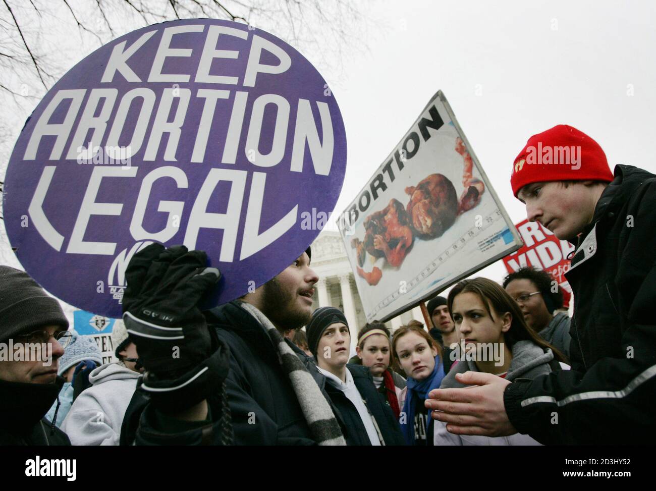 Pro-choice activist Luqman Clark (L), of Arlington, VA, argues with a group of anti-abortion protestors outside the U.S. Supreme Court in Washington January 24, 2005, during the 32nd annual March For Life protest against the Supreme Court's decision in the Roe v. Wade abortion rights decision. Thousands of pro-life activists marched to the Supreme Court where they were met by a handful of pro-choice campaigners. REUTERS/Jason Reed  JIR Stock Photo