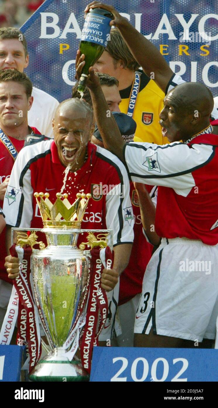 Arsenal S Thierry Henry L Has Champagne Poured Over His Head By Team Mate Sol Campbell R As He Holds The Fa English Premier League Trophy Having Won The Double After Their Match