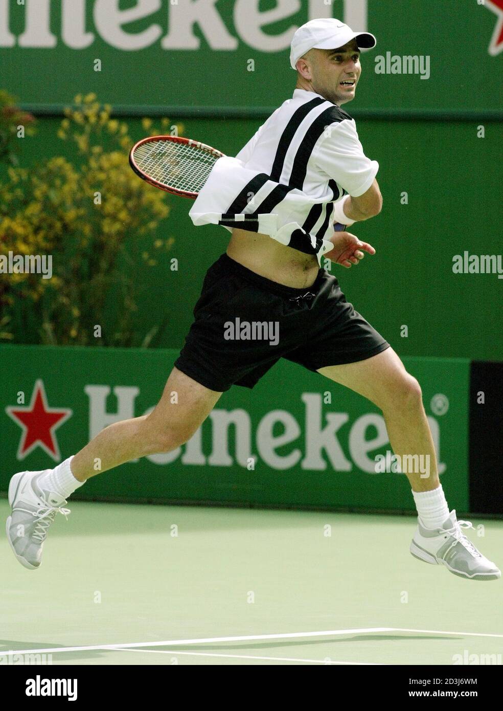 Andre Agassi of the United States follows through on a return while playing  compatriot Brian Vahaly during their match at the Australian Open in  Mellbourne January 13, 2003. Number two seed Agassi