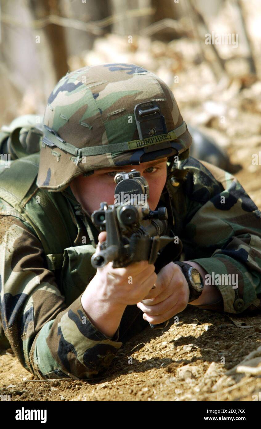 An infantrymen from the U.S. Army 2nd Infantry Division aims his weapon during training for the coveted Expert Infantryman Badge at Camp Casey, north of Seoul, March 19, 2003. American ally South Korea is host to 37,000 U.S. troops in about 100 installations across the country. REUTERS/Darren Whiteside  DW/FA Stock Photo