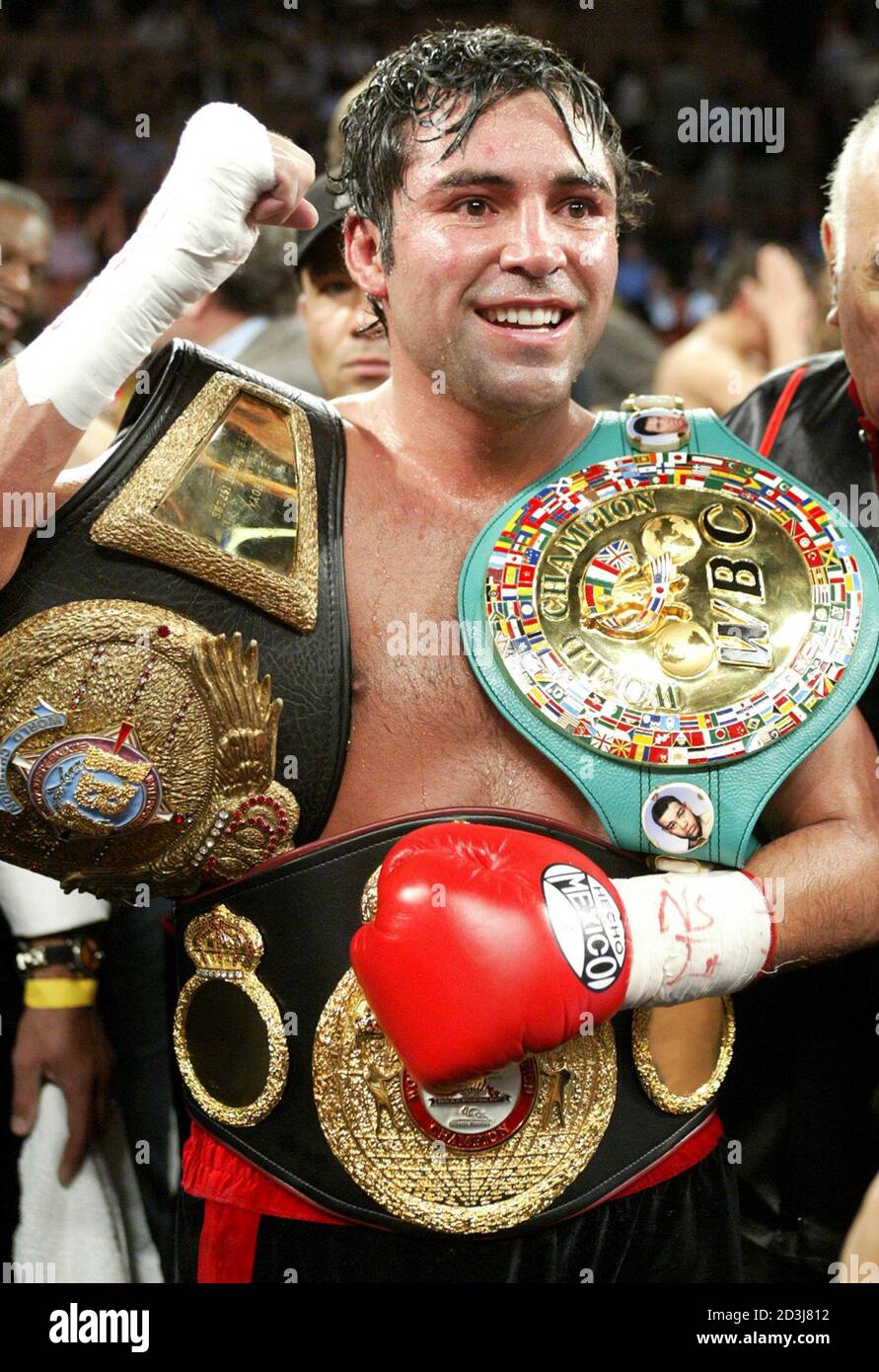 WBC/WBA super welterweight champion Oscar De La Hoya of Los Angeles poses with belts after defeating Yory Boy Campas of Navojoa, Mexico at the Mandalay Bay Events Center in Las Vegas, Nevada, May 3, 2003. De La Hoya won the fight with a technical knockout when referee Vic Drakulich stopped the fight in the seventh round. REUTERS/Steve Marcus  SM/GAC Stock Photo