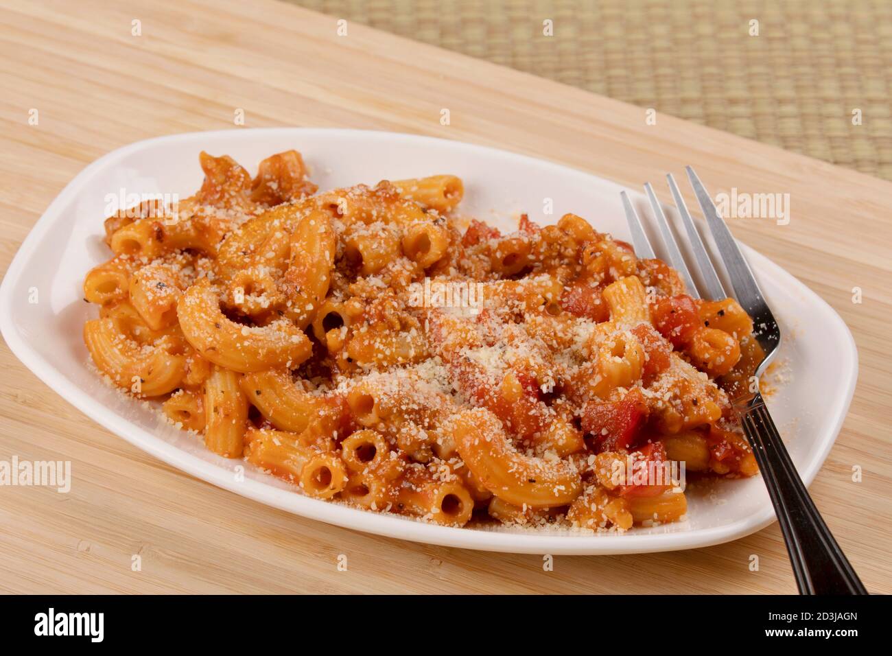 A delicious meal of elbow macaroni with pasta sauce and parmesan cheese Stock Photo