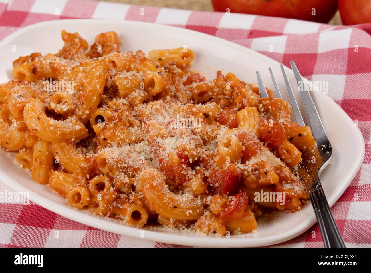 A delicious meal of elbow macaroni with pasta sauce and parmesan cheese