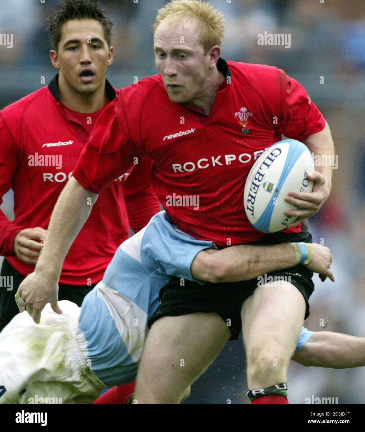 Argentine side Los Pumas' Hernan Senillosa (obscured) tackles Wales' Tom  Shanklin (R) during their second rugby